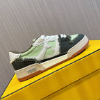 Fendi low-top sneakers on yellow box, white laces, lime green and black panels, cream sole.