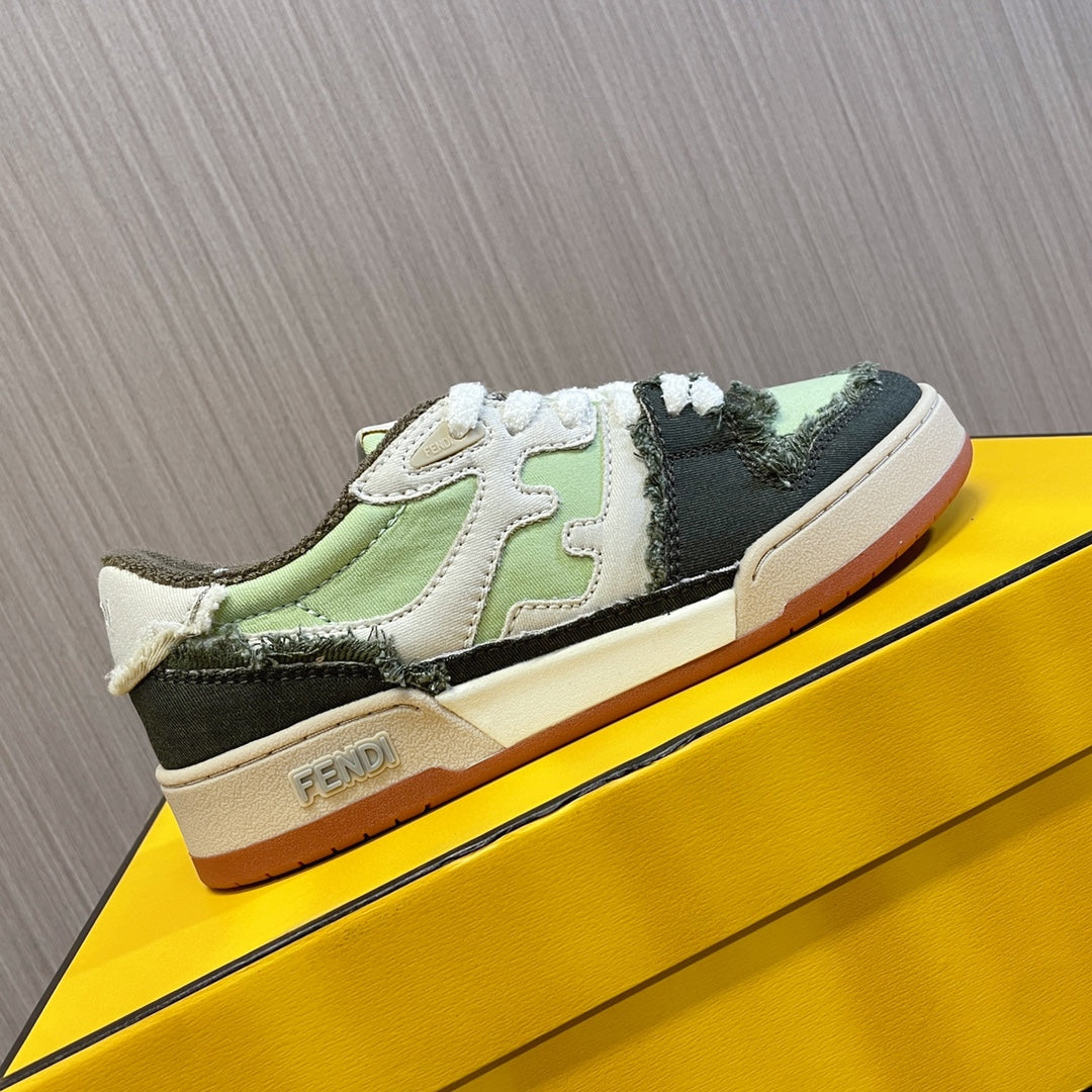 Fendi low-top sneakers on yellow box, white laces, lime green and black panels, cream sole.