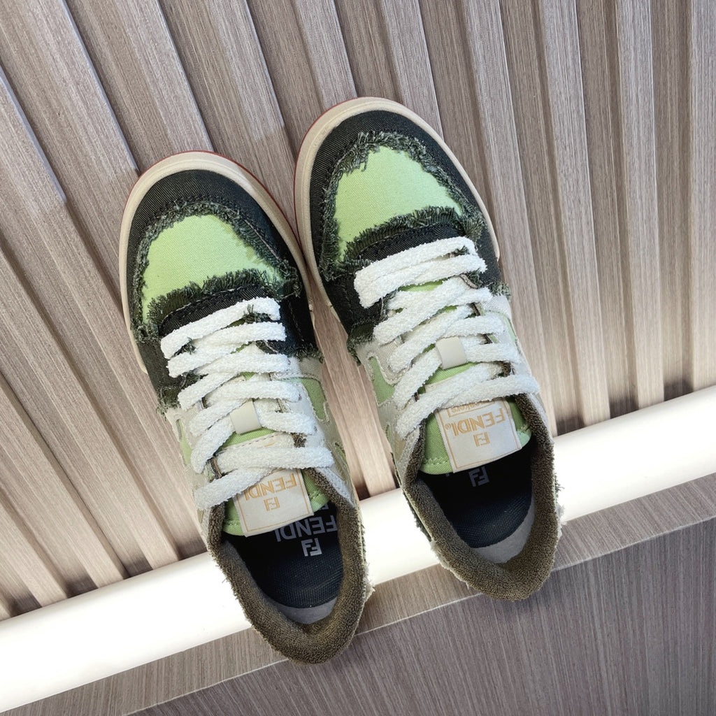Fendi low-top sneakers, white laces, lime green/black panels, cream rubber sole.