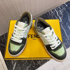 Fendi low-top sneakers with white laces, lime green and black uppers, on yellow box.