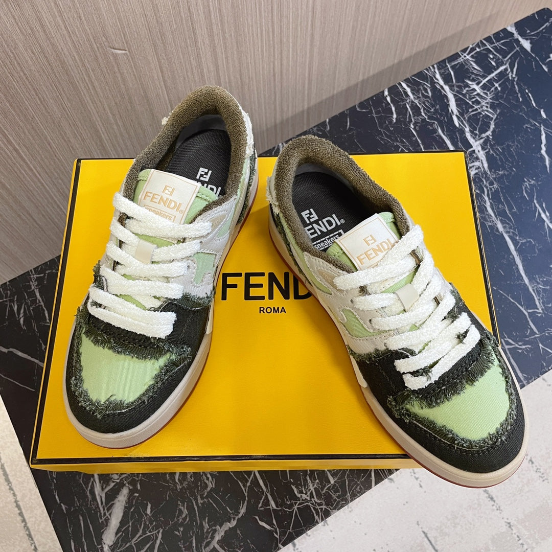 Fendi low-top sneakers with white laces, lime green and black uppers, on yellow box.
