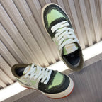 Fendi low-top sneakers with white laces, lime green top, black side stripe, cream sole.