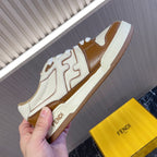Unisex Fendi leather sneakers held by hand, white with brown panels and cream trim