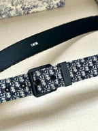Louis Vuitton belt close-up: blue monogram strap with black rectangular buckle