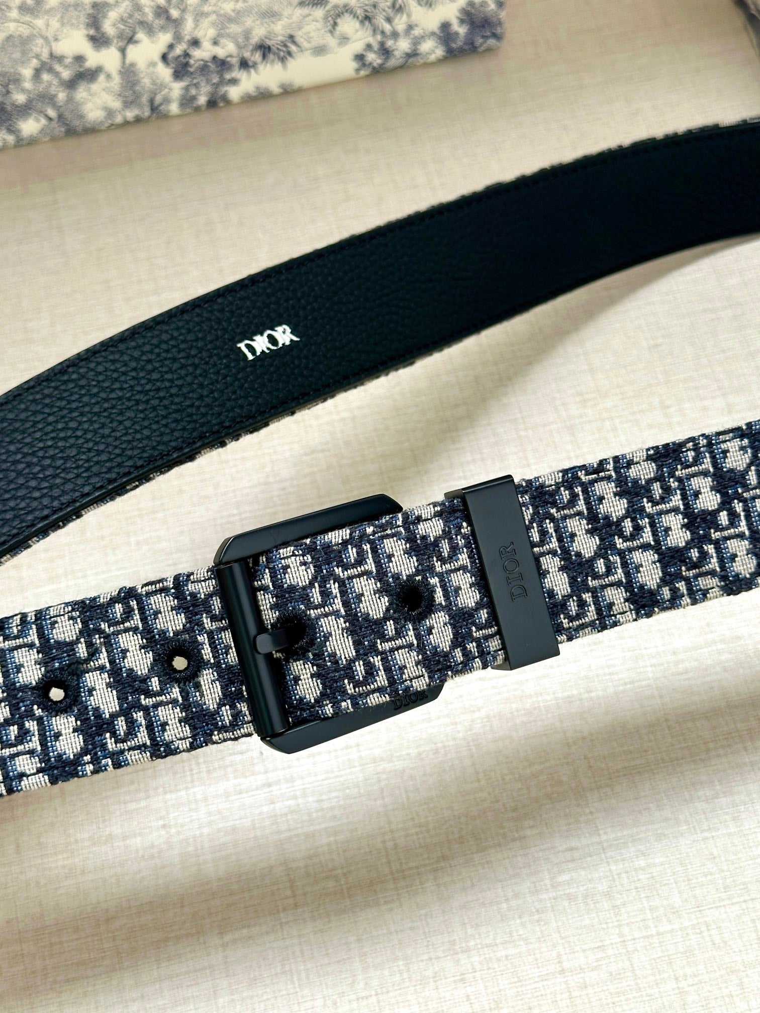 Louis Vuitton belt close-up: blue monogram strap with black rectangular buckle
