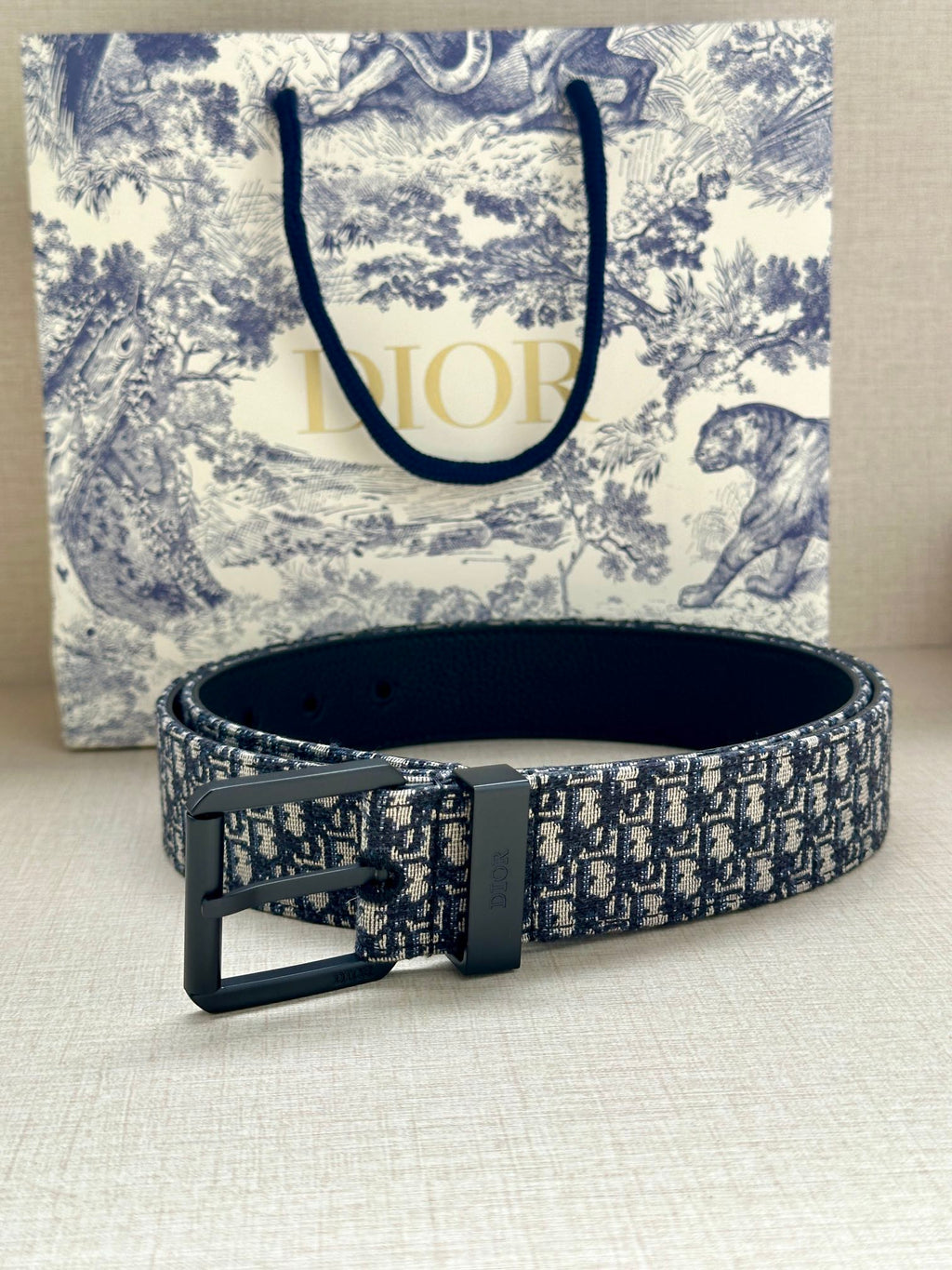 Louis Vuitton belt with blue monogram strap and large black pin buckle