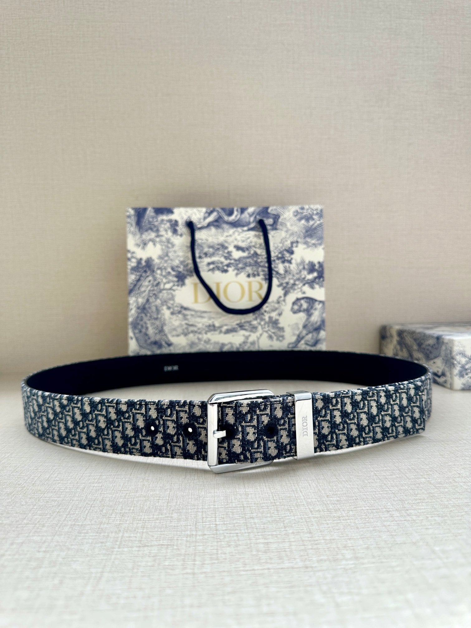 Dior belt with navy-and-white patterned strap and silver-toned rectangular buckle