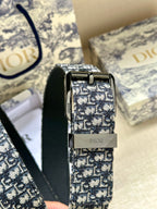 Dior belt close-up: blue jacquard strap with silver buckle and black leather underside