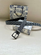 Dior belt laid flat: blue monogram jacquard strap with square pin-buckle