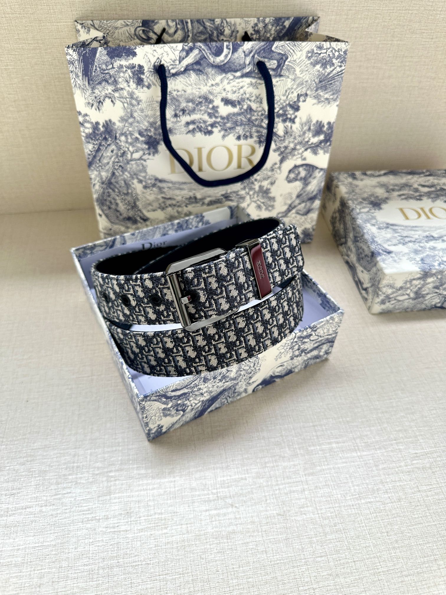 Dior belt in blue patterned jacquard with silver buckle, shown in gift box