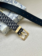 Navy leather-back Dior belt with gold buckle and multiple adjustment holes