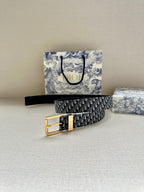 Navy Dior belt with Dior monogram pattern and gold buckle, laid flat