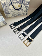 Multiple Dior belt straps with different buckle finishes: black, silver, and gold