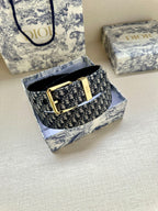 Dior monogram belt with gold buckle shown in box and black belt underside