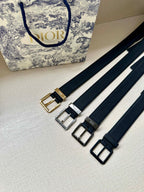 Assorted Dior belt straps with buckles in gold, silver, and black on navy webbing