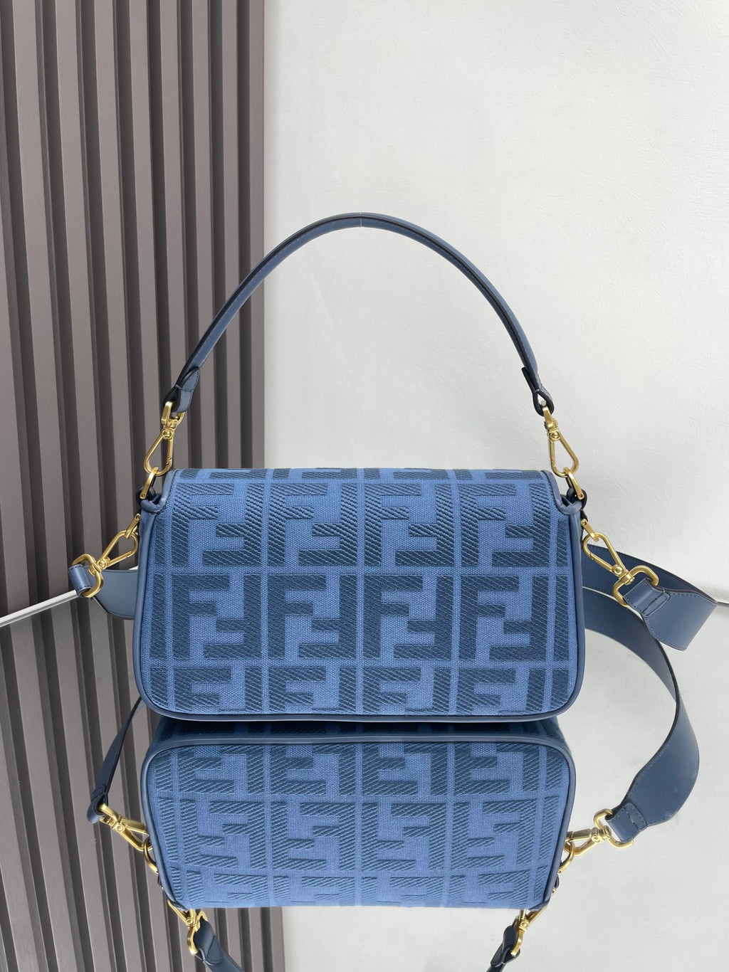 Fendi bag blue FF monogram flap with gold hardware and crossbody strap, front view