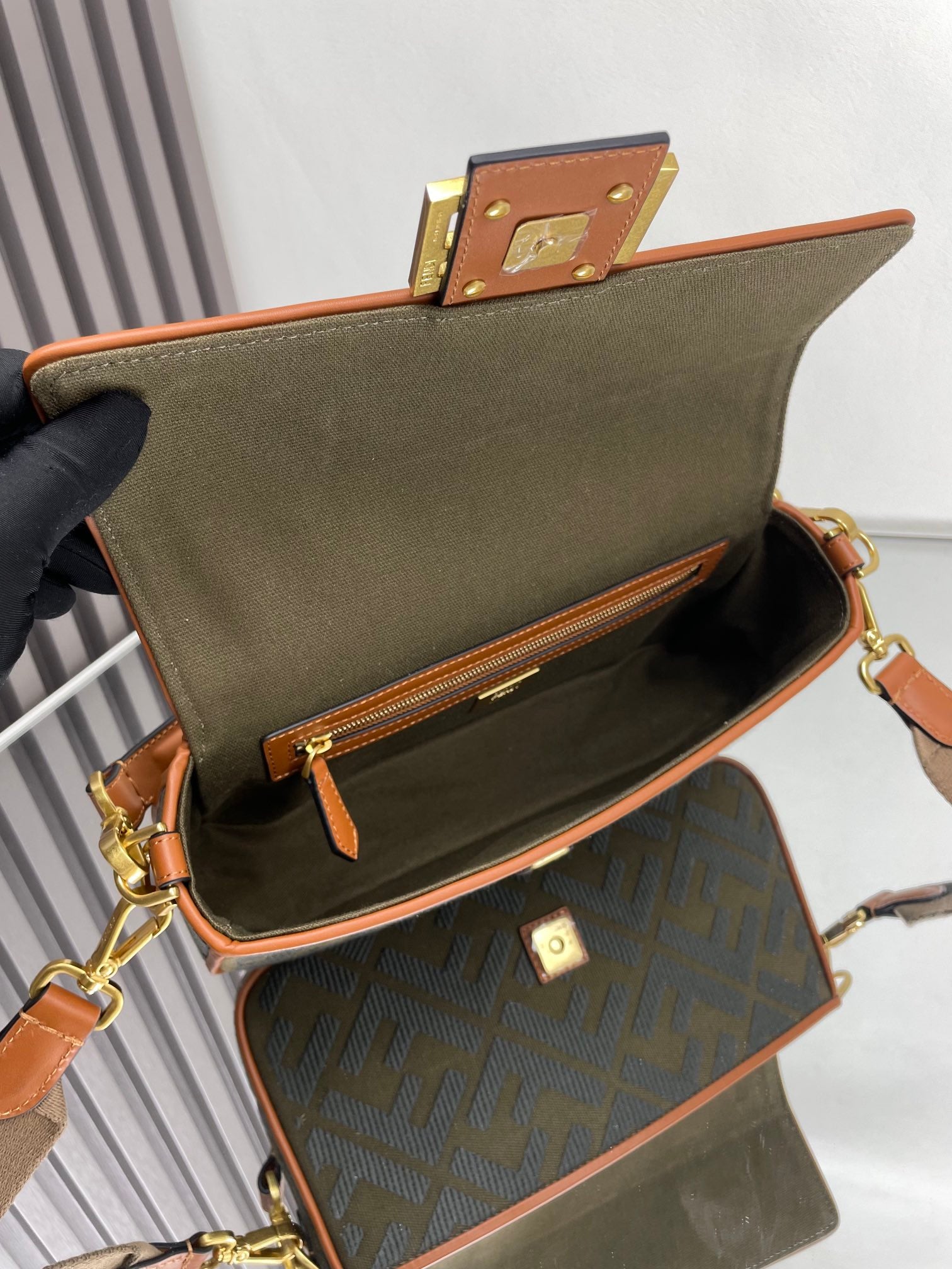 Fendi bag open top view showing interior and logo pouch with brown leather edges