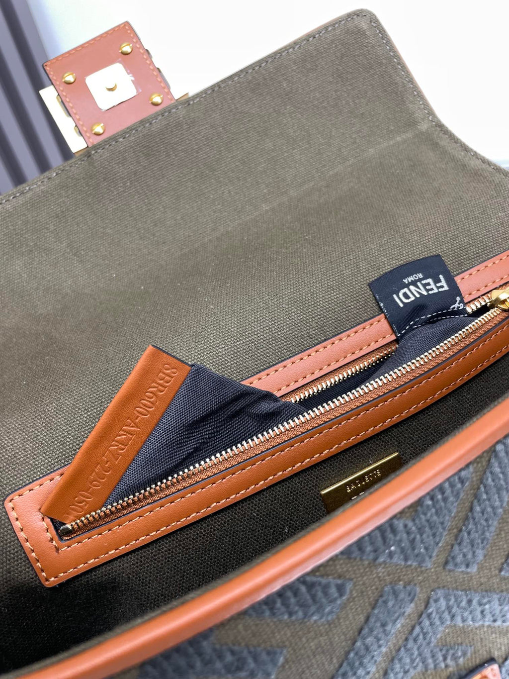 Fendi small bag interior pocket with navy FENDI fabric lining and zip closure