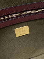 FENDI label on Fendi baguette bag interior, gold tag with olive canvas and burgundy trim