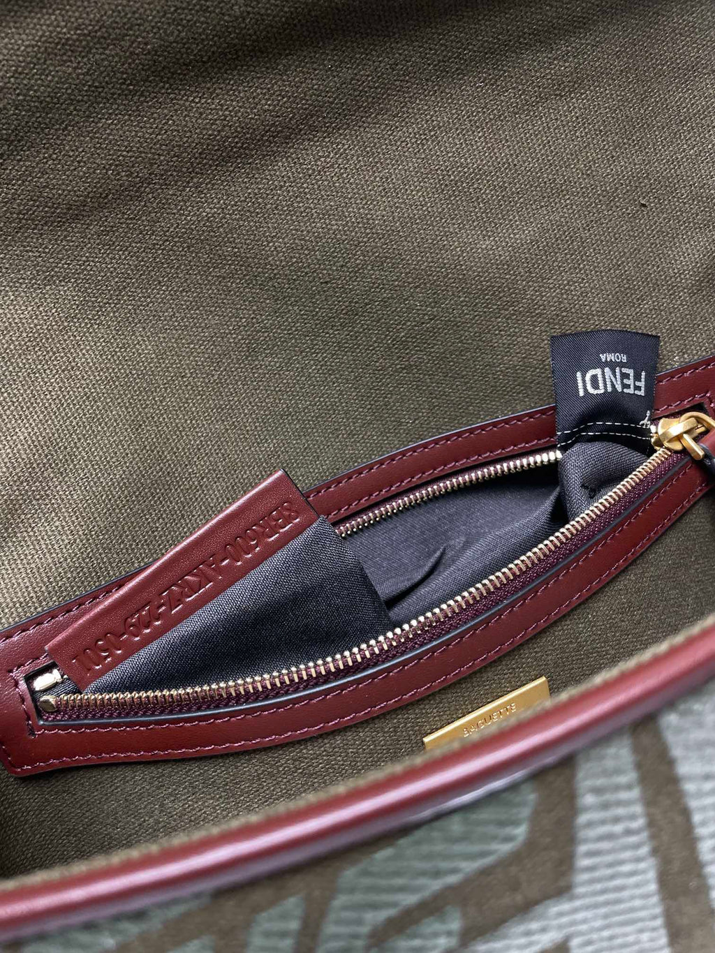 Fendi baguette bag interior pocket, maroon zipper trim and navy fabric lining