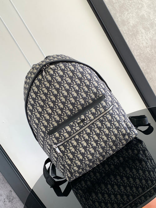 Dior men's backpack in blue-and-beige monogram canvas with black webbing straps