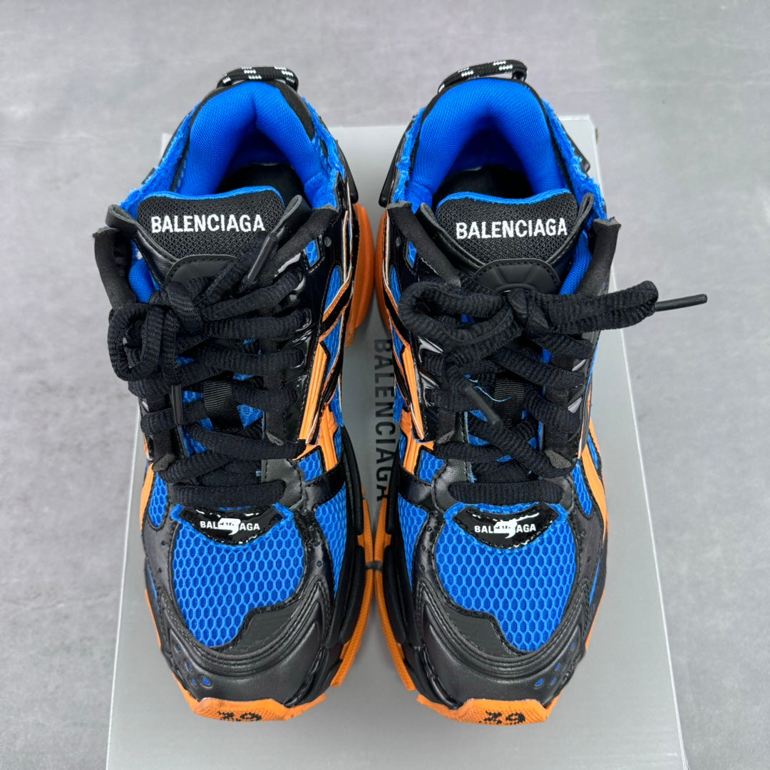 Balenciaga sneakers back view, black heel tabs and blue uppers with orange details, laces