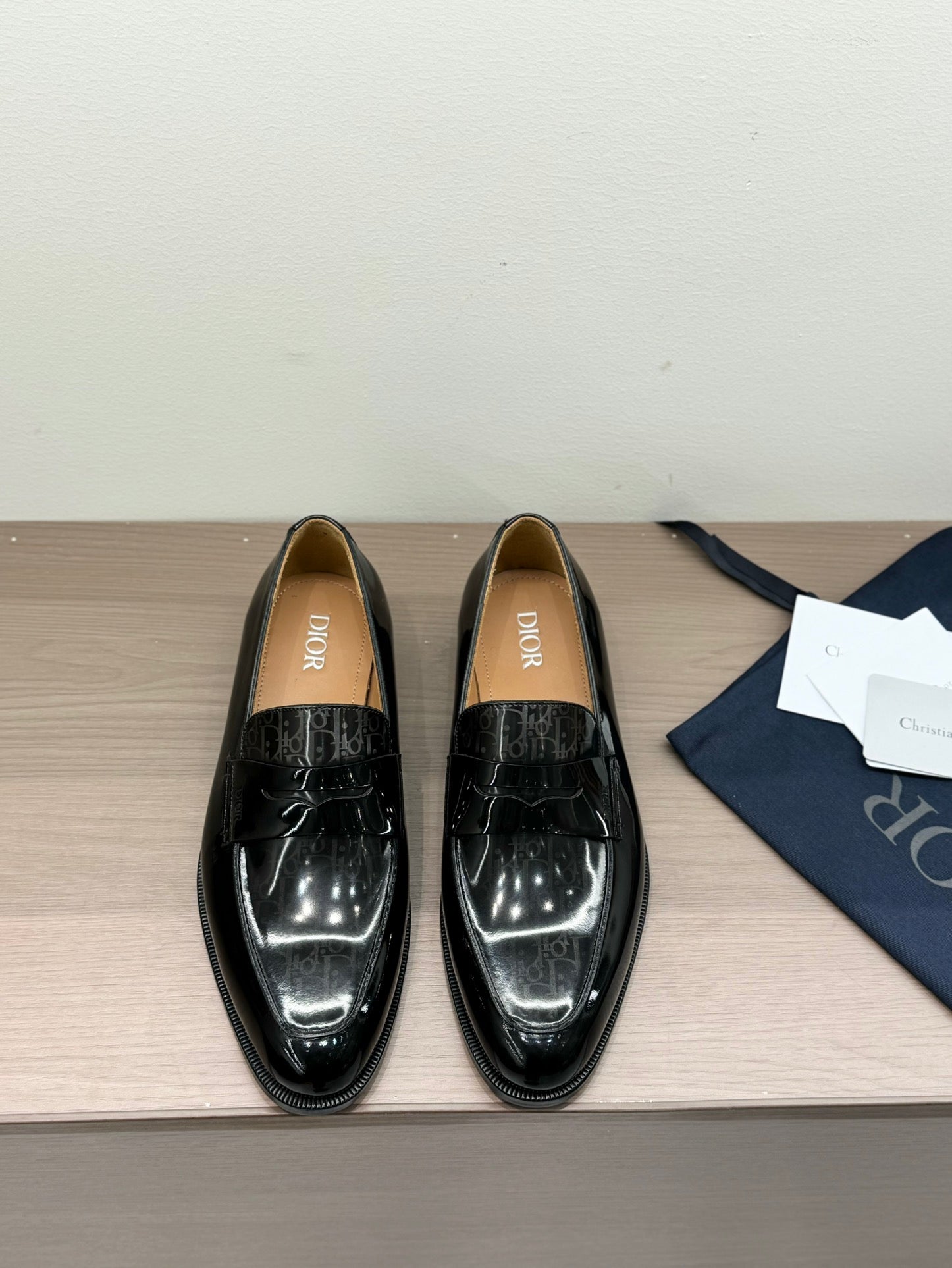 Unisex black patent loafers with front buckle detail, glossy finish