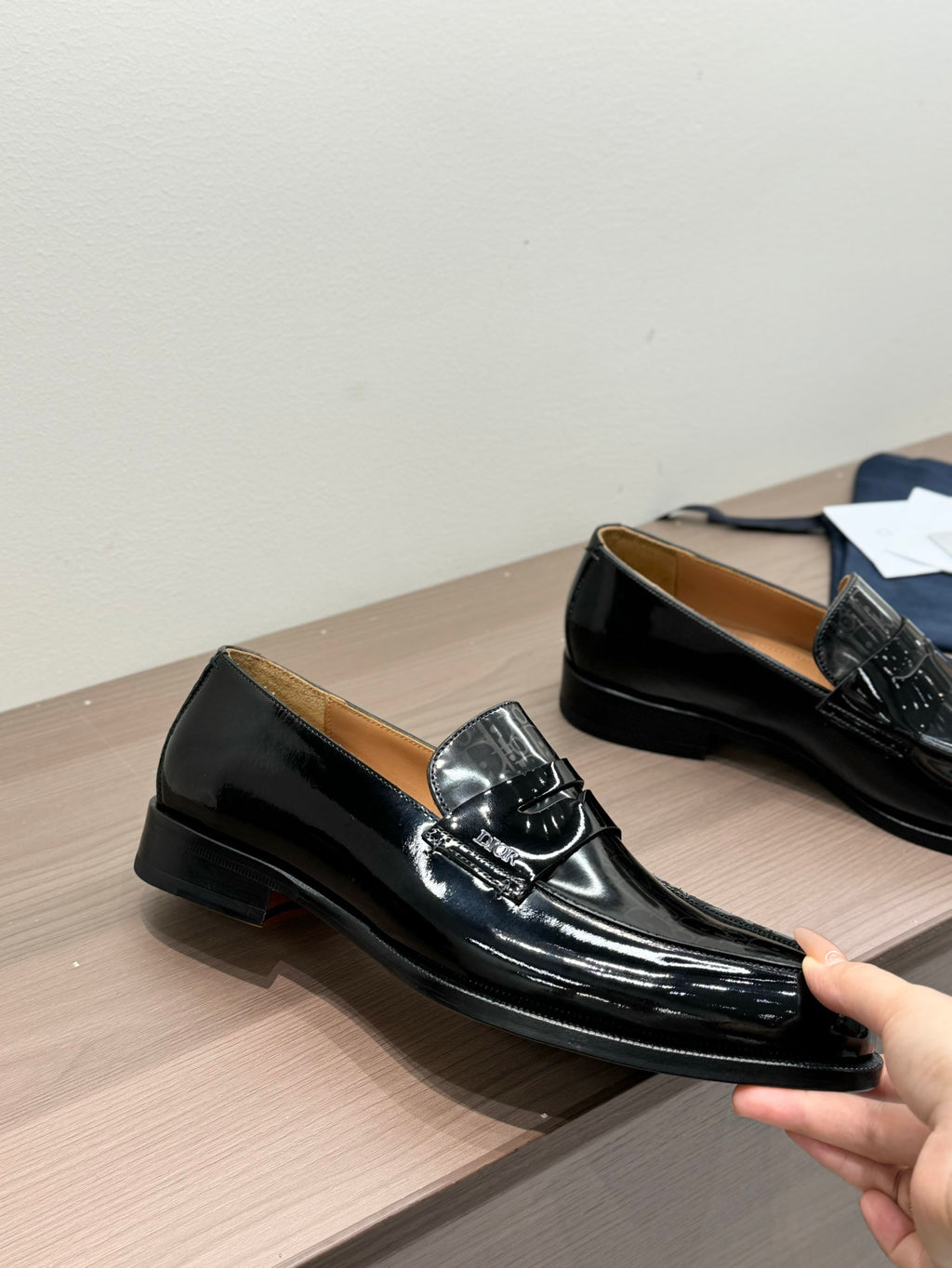 Unisex black patent loafers, low block heel, side view with buckle strap