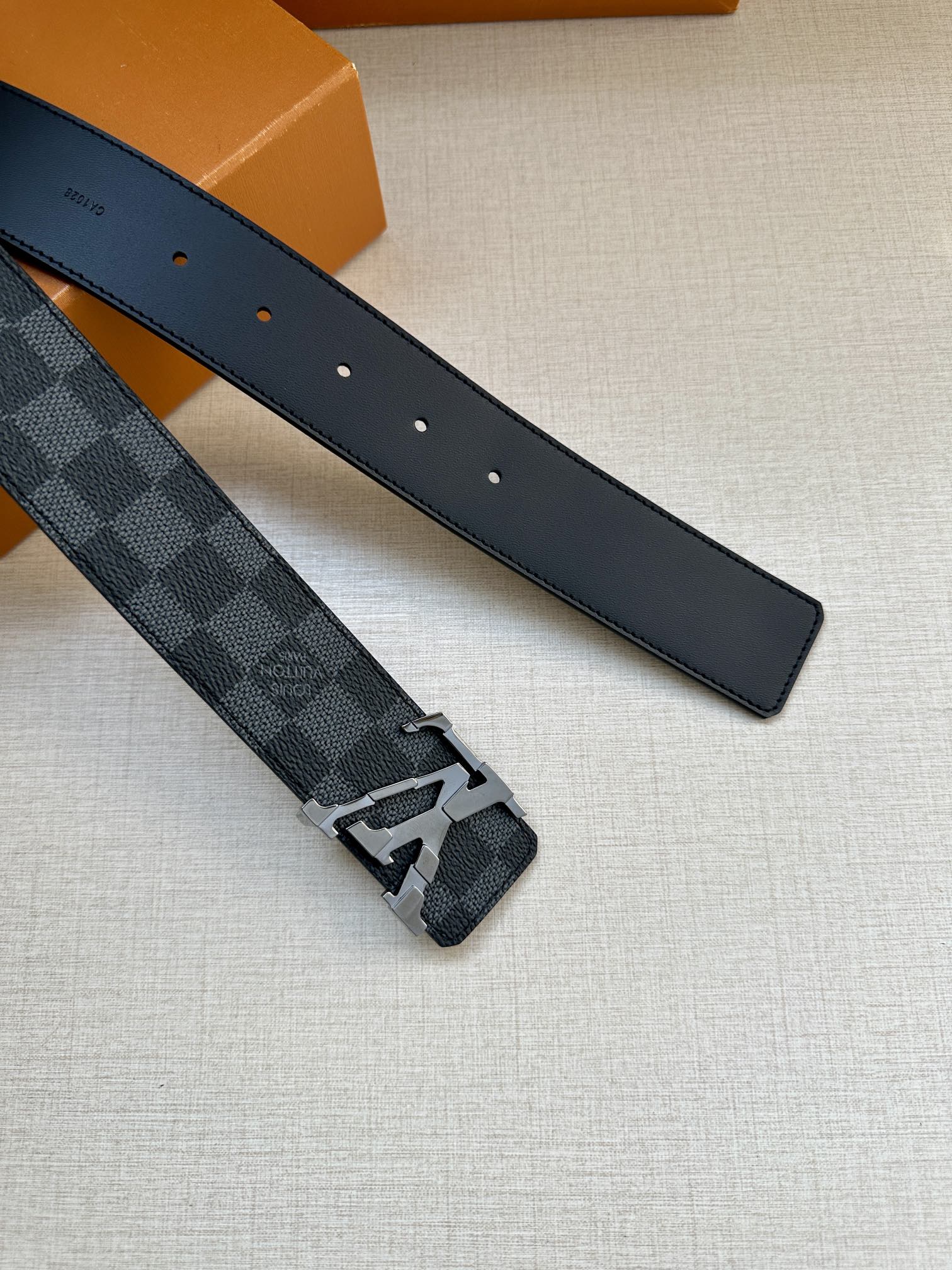 Louis Vuitton patterned leather belt with metal buckle and matching dark strap