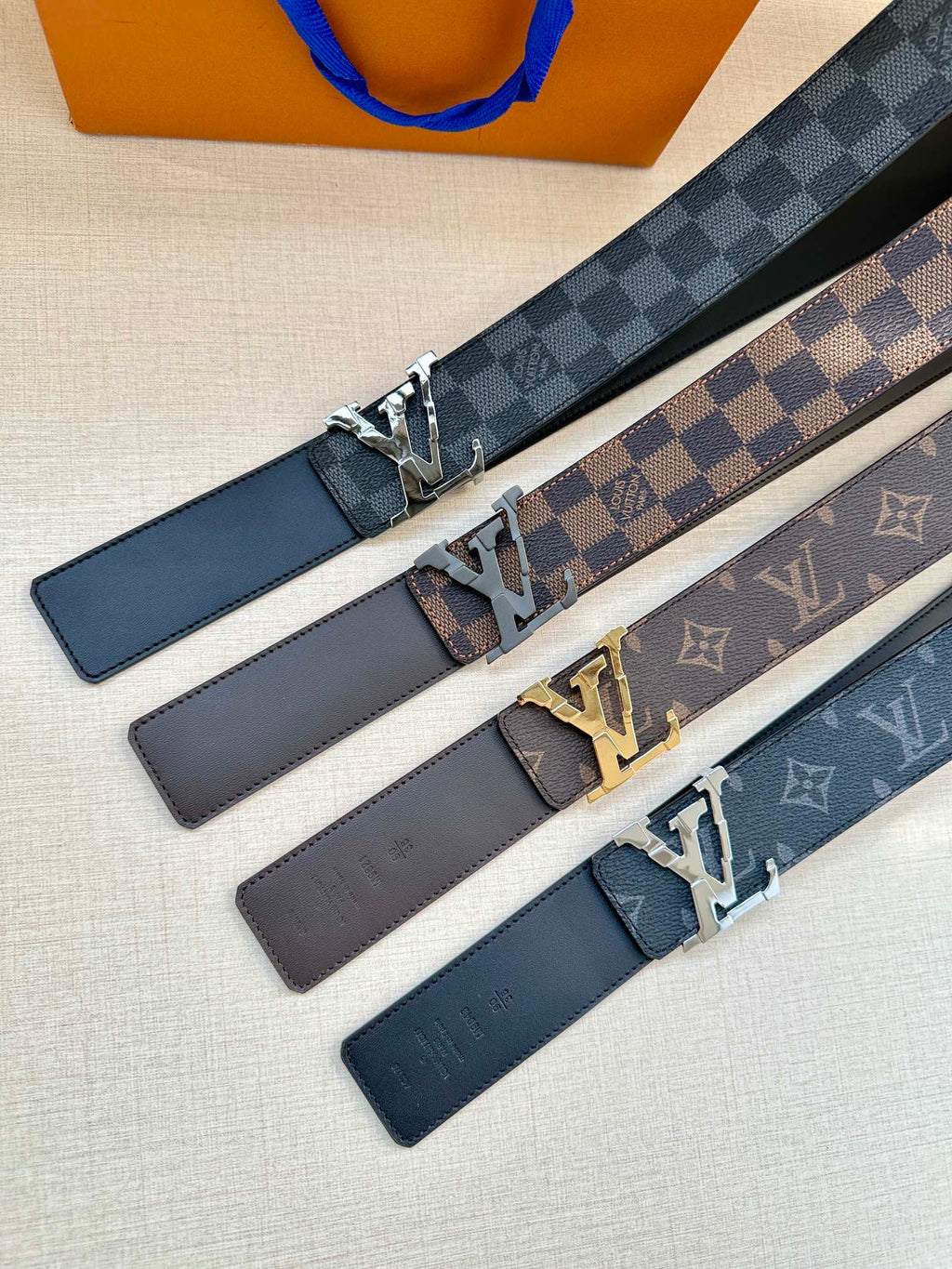 Louis Vuitton set of patterned belts with silver buckles in dark and brown tones
