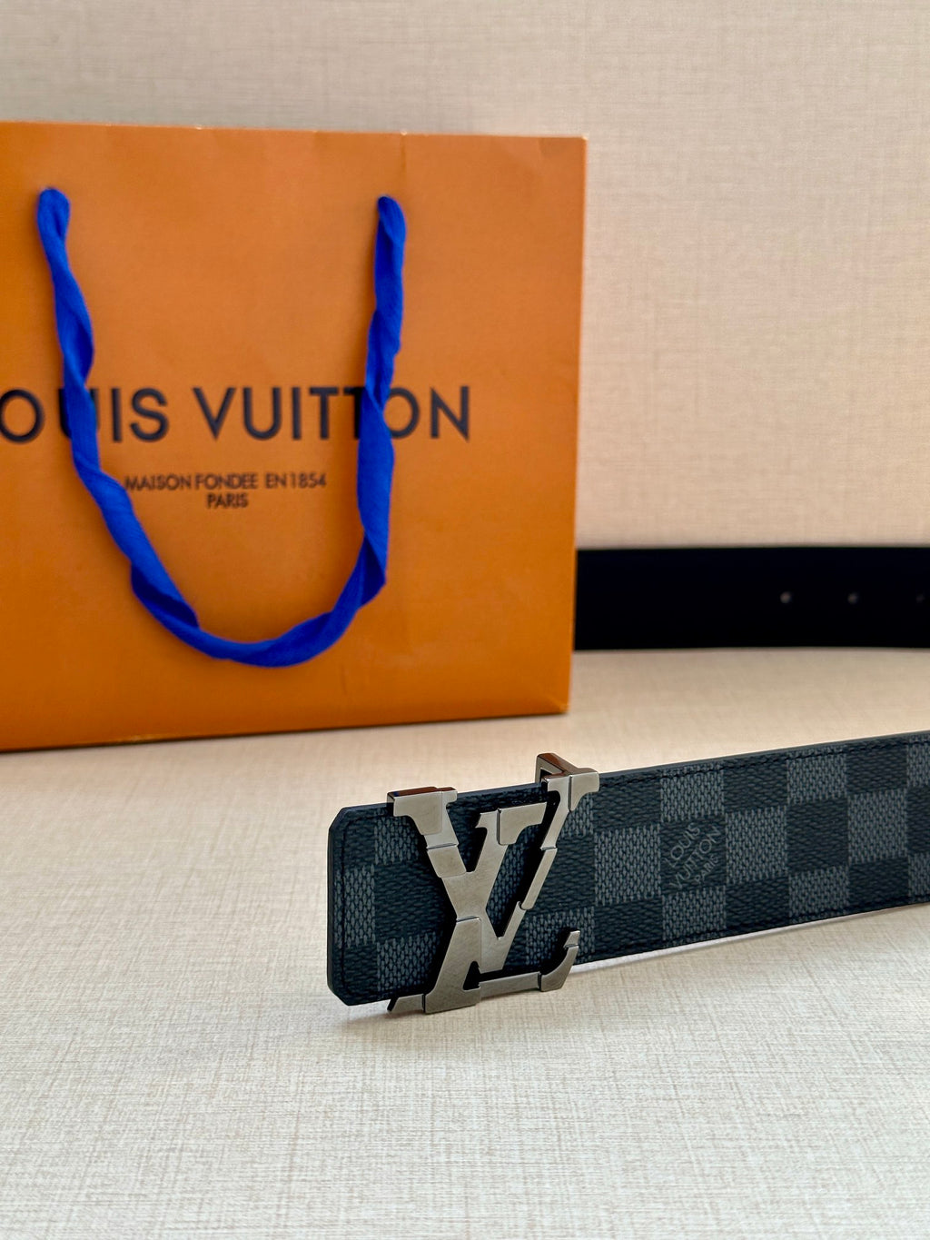 Louis Vuitton patterned belt with oversized silver buckle and smooth strap