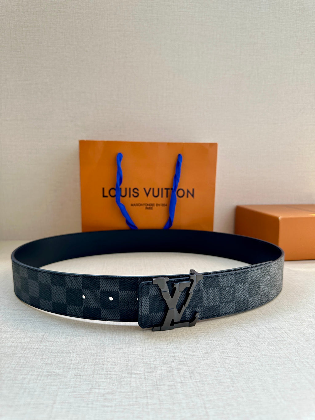 Louis Vuitton patterned canvas belt with dark buckle and embossed LV emblem