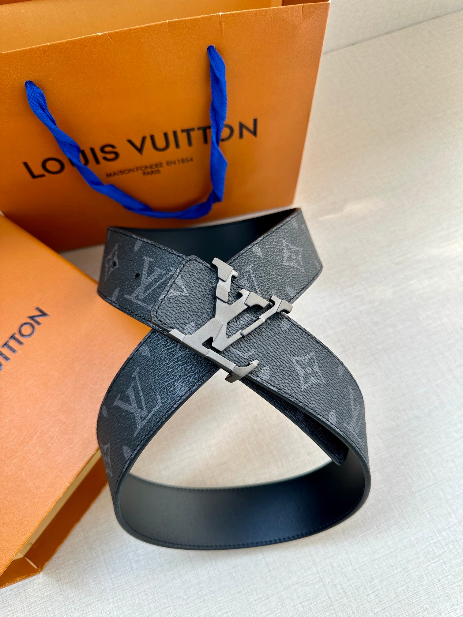Dark monogram leather belt with silver-tone buckle and belt loop detail