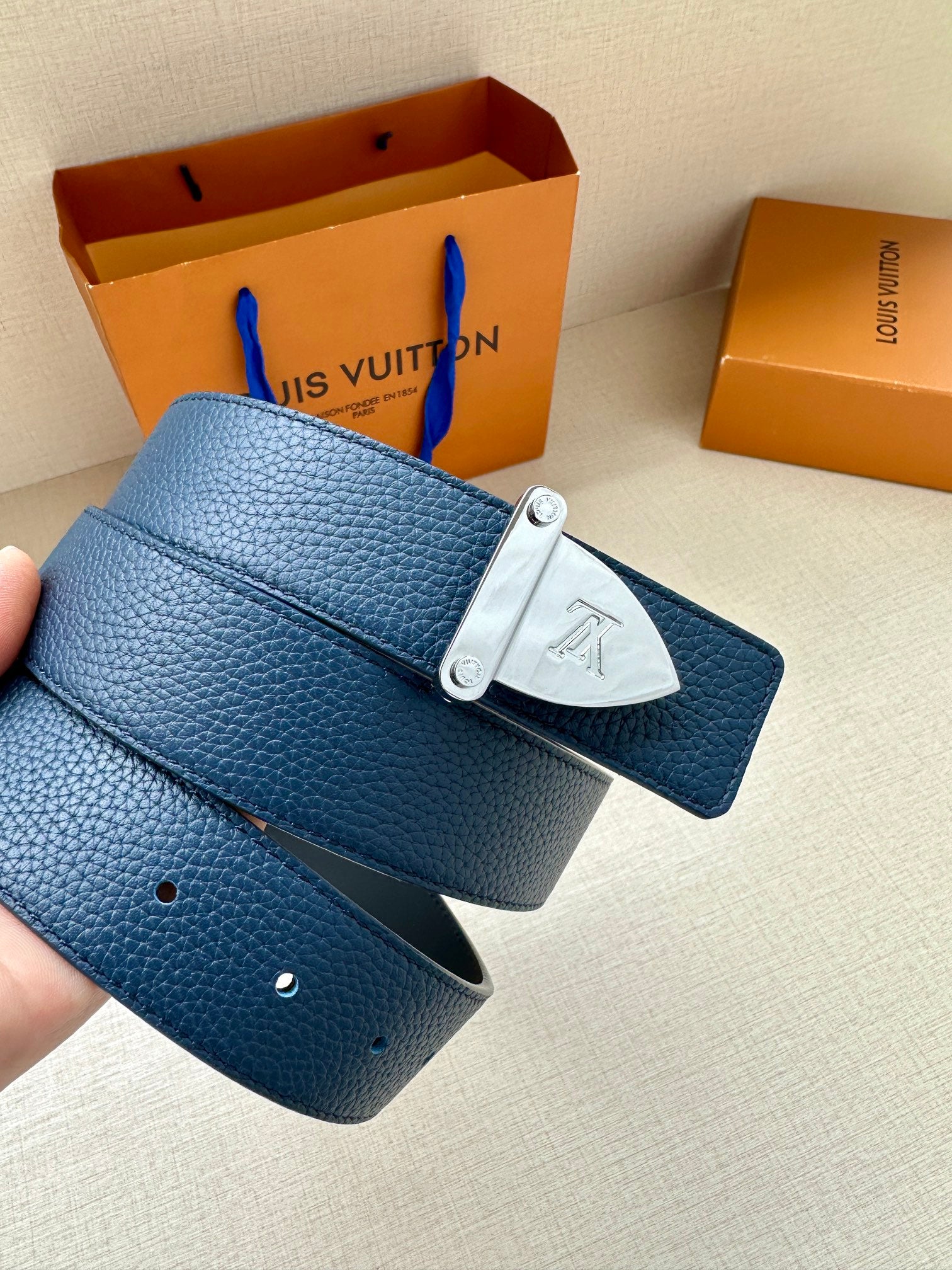 Blue leather belt with silver LV buckle and belt holes