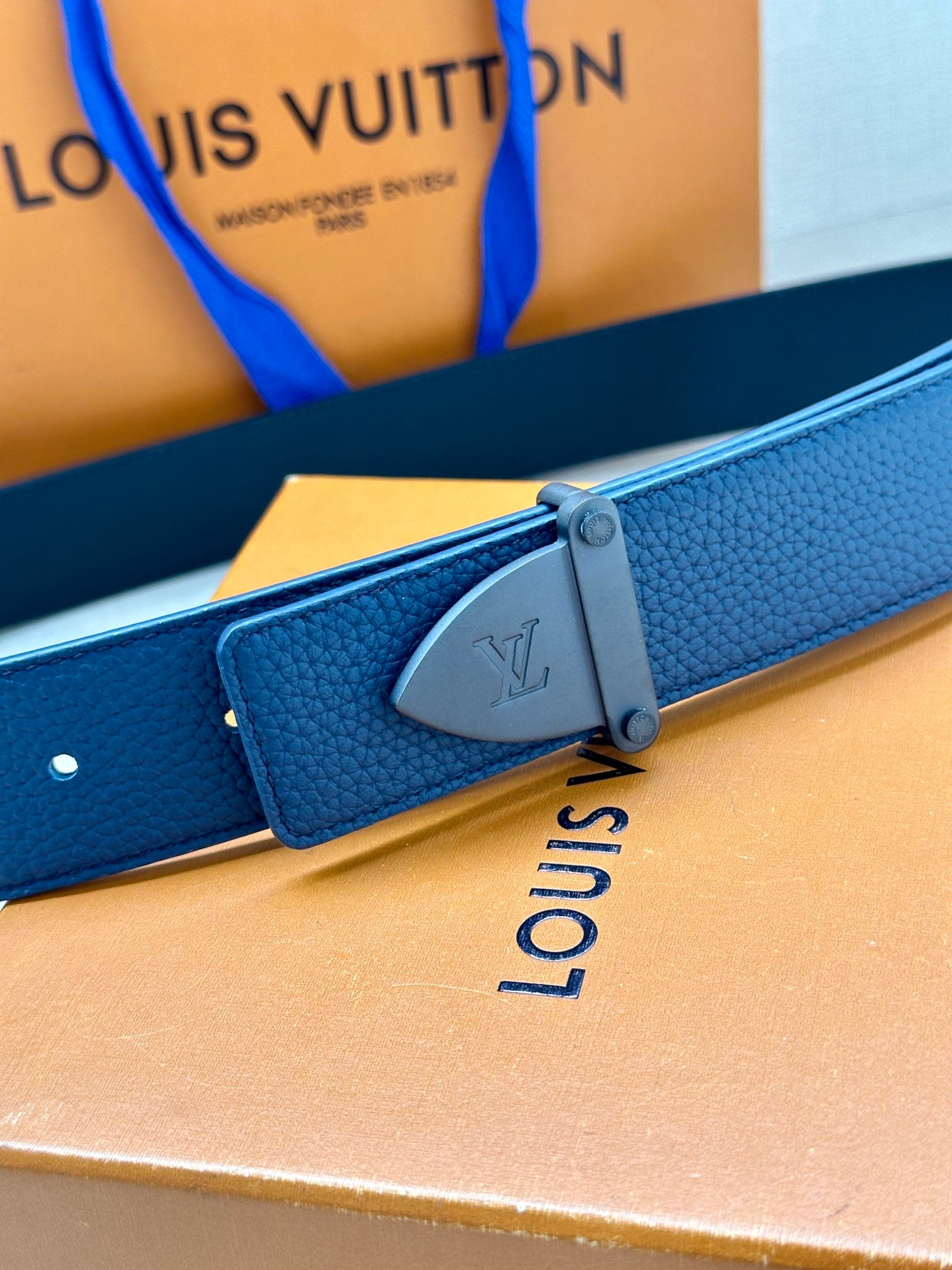 Louis Vuitton blue leather belt with silver-tone buckle across the strap