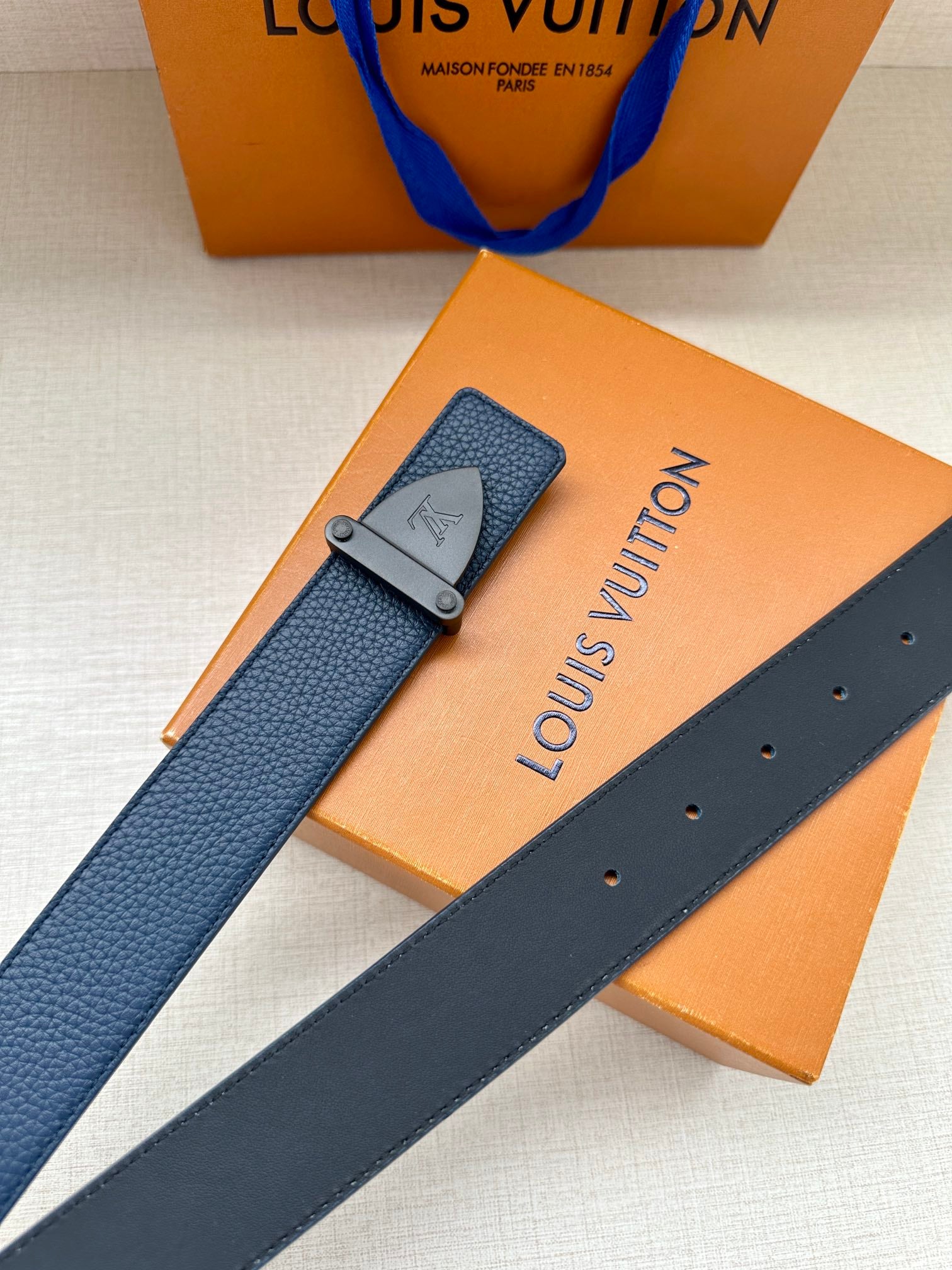 Louis Vuitton blue textured belt with silver-tone buckle and stud holes