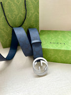 Gucci belt close-up, navy blue strap with silver-tone GG logo buckle