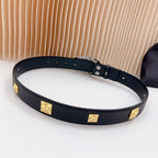 Leather belt with dark blue strap, gold square studs, and metal buckle