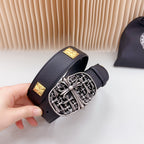 Leather belt buckle detail: ornate silver buckle with gold square studs on strap