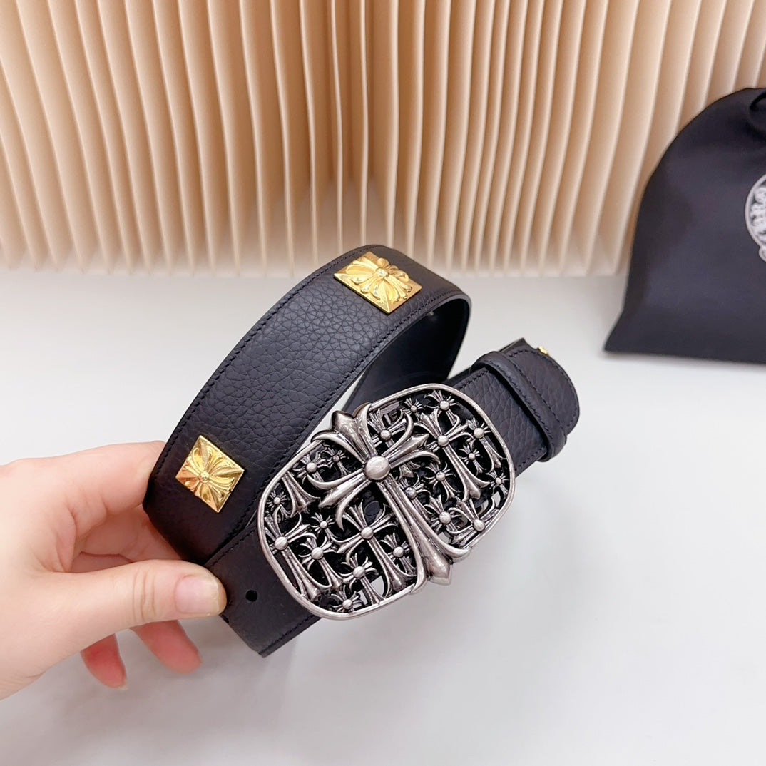Leather belt buckle detail: ornate silver buckle with gold square studs on strap
