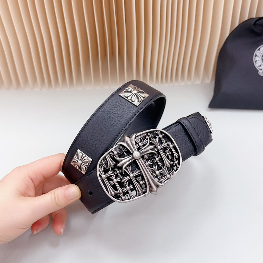 Navy leather belt detail with ornate silver buckle and cross-shaped plates
