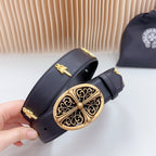 Dark leather belt close-up with gold filigree buckle and decorative bar accents