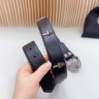 Dark leather belt strap close-up with adjustment bar and silver-tone buckle