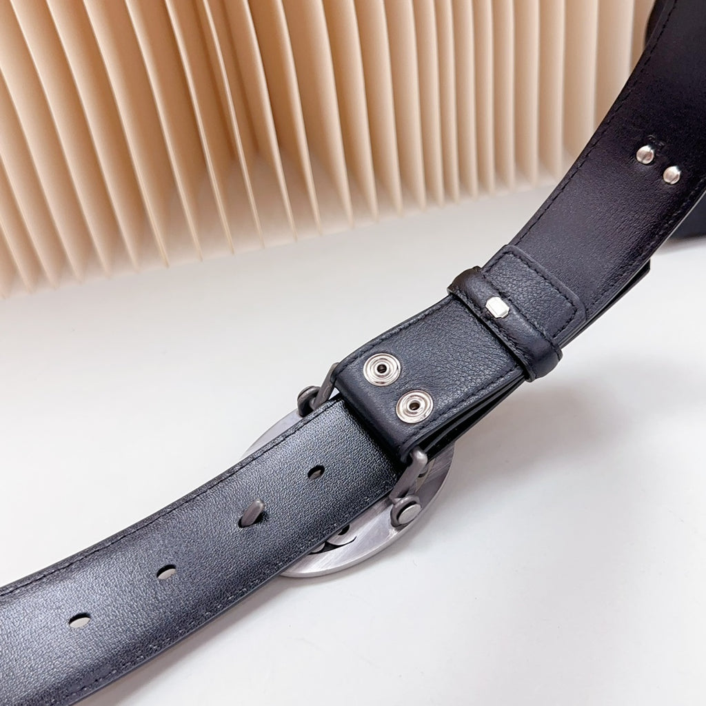 Dark leather belt close-up of adjustment strap with silver-tone fasteners