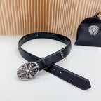 Dark leather belt with ornate oval silver buckle and long extended strap