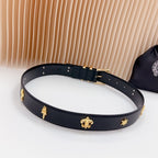 Navy leather belt with gold buckle and charm accents, shown in a full loop