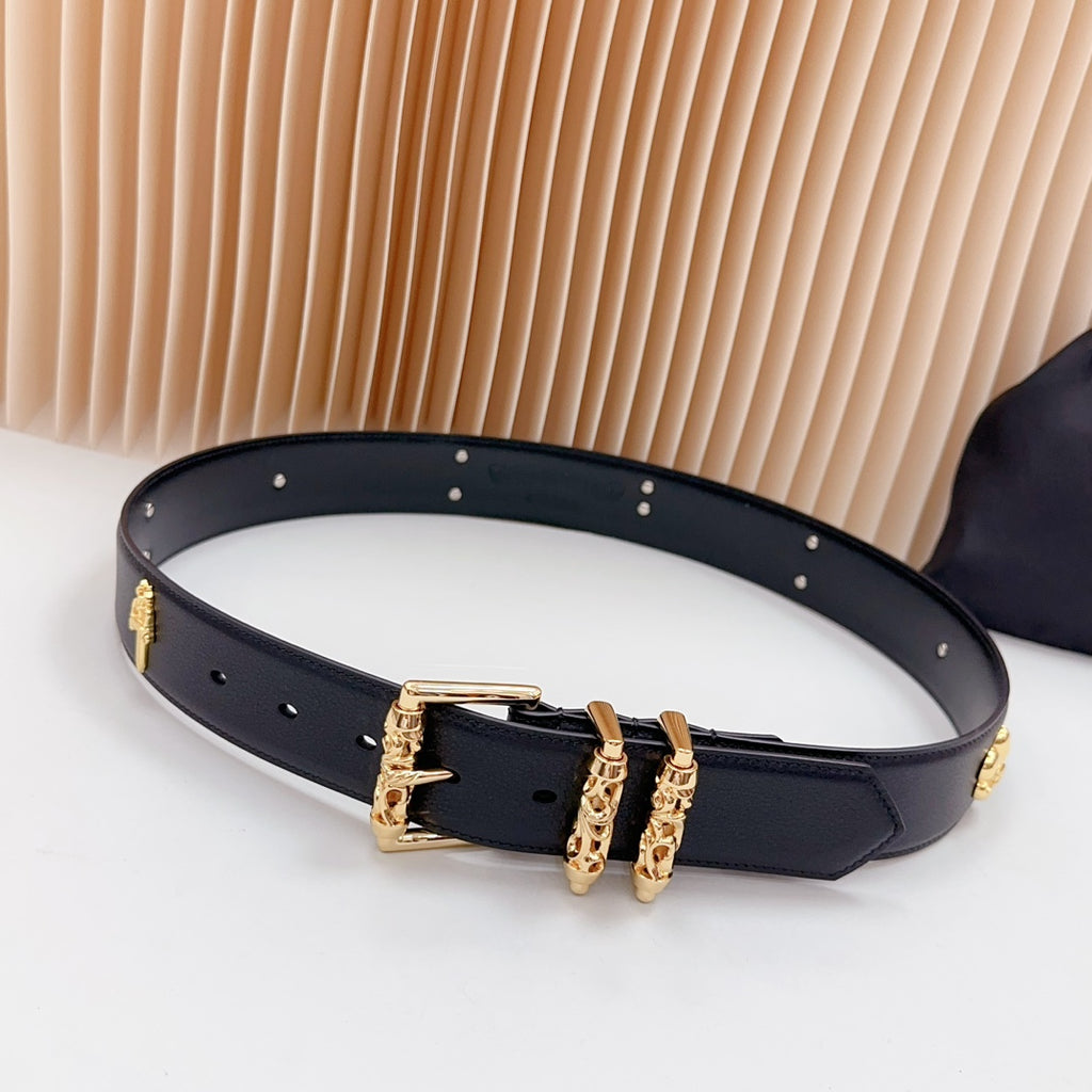 Navy leather belt with gold buckle and decorative charms along the strap