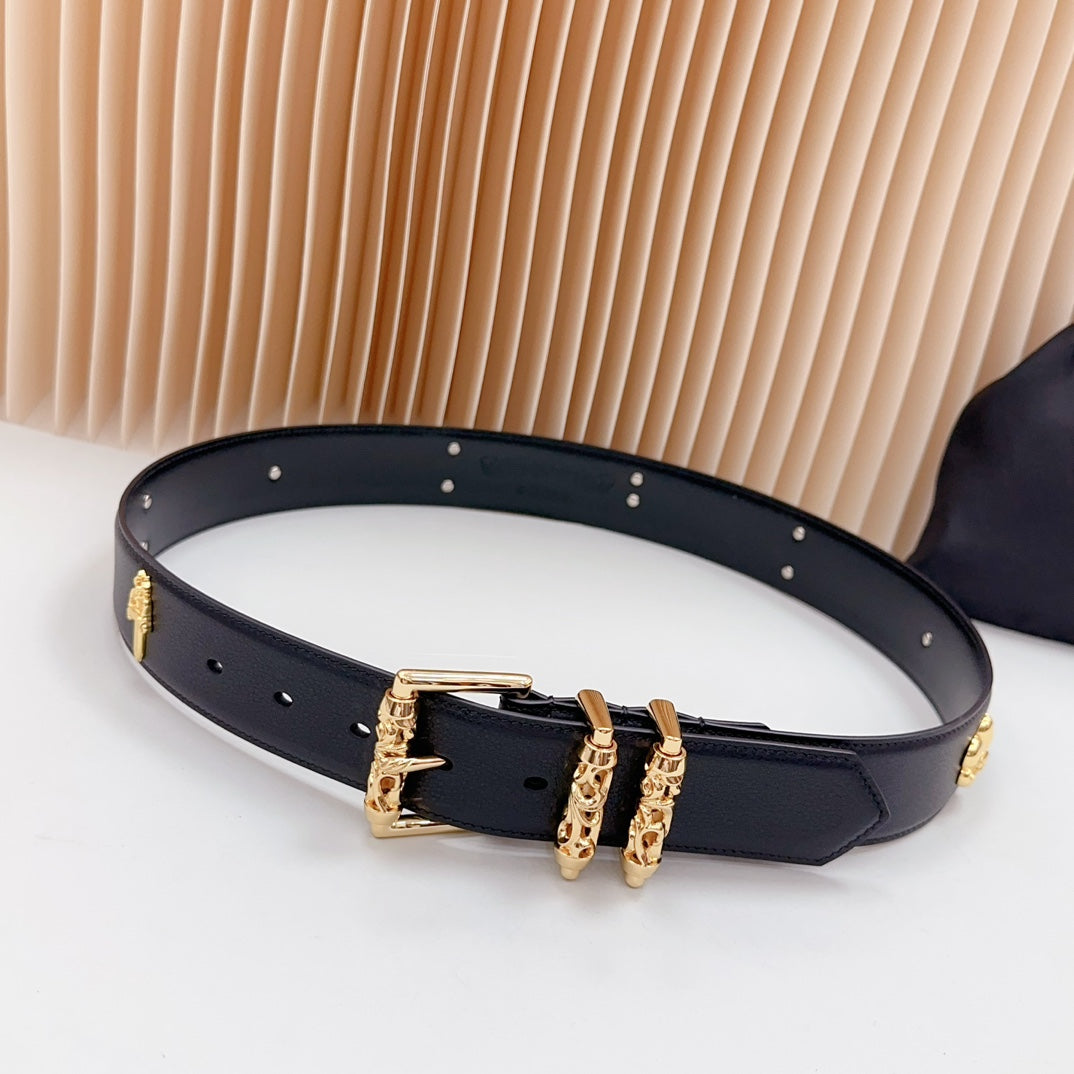 Navy leather belt with gold buckle and decorative charms along the strap