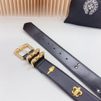 Navy leather belt with gold buckle, cross charm, fleur-de-lis emblem, and stud holes