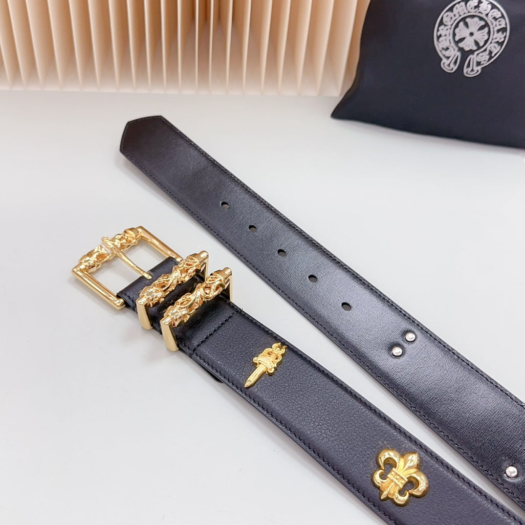 Navy leather belt with gold buckle, cross charm, fleur-de-lis emblem, and stud holes